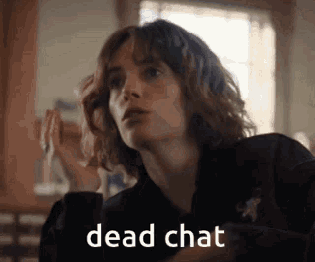a woman in a black jacket with the words dead chat written on it