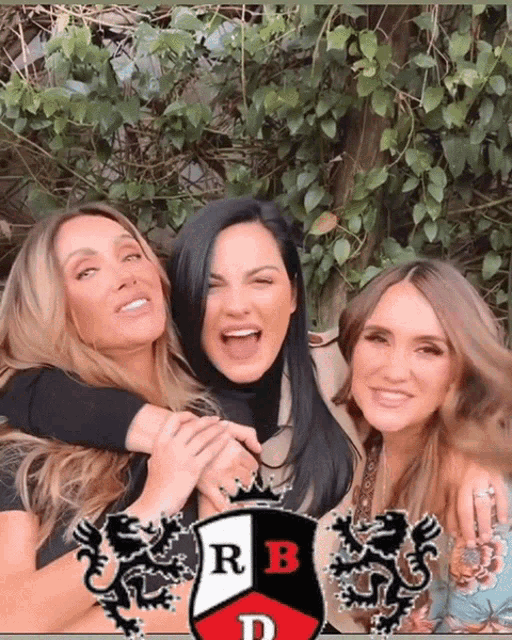 three women are posing for a picture with a crest that says rb d on it