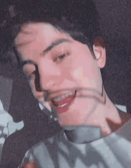 a close up of a man 's face with a shadow on his face .
