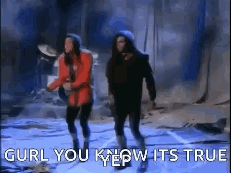 two men are dancing on a stage with the words `` gurl you know it 's true '' written below them .