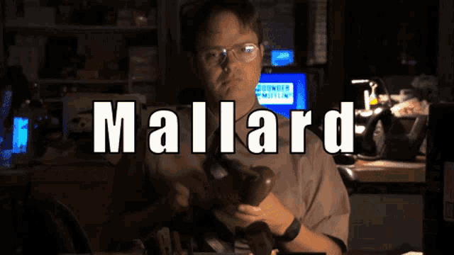 a man holding a telephone with the name mallard written on it