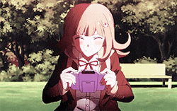 a girl is sitting in a park holding a purple item .