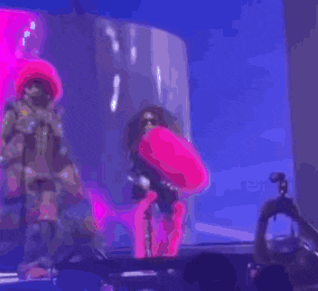 a blurry picture of a group of people dancing on stage