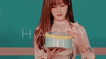 a young woman is holding a gift box in her hands and smiling .