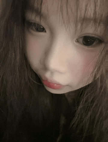a close up of a woman 's face with long hair