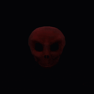 a red sphere is floating in the dark
