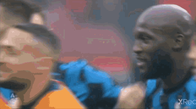 a blurred image of a soccer player with x rec written on the bottom left