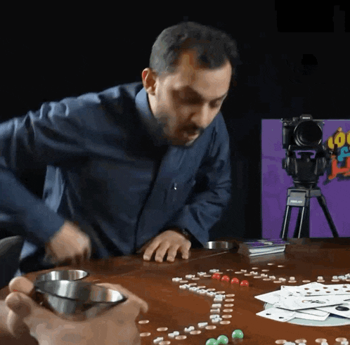 a man playing a game with a camera on a tripod that says nikon