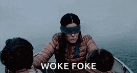 a woman with blindfolds is sitting in a boat with other people and says woke foke .