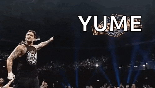 a man in a black tank top is standing in front of a sign that says yume on it