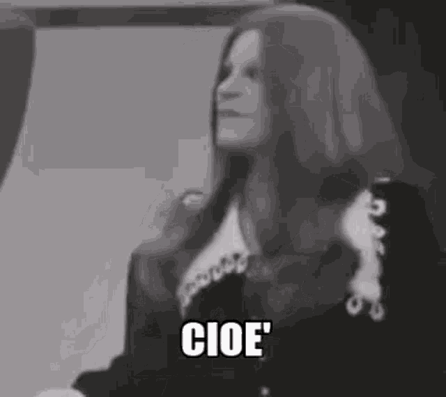 a black and white photo of a woman with long red hair and the words cioe written on the bottom .