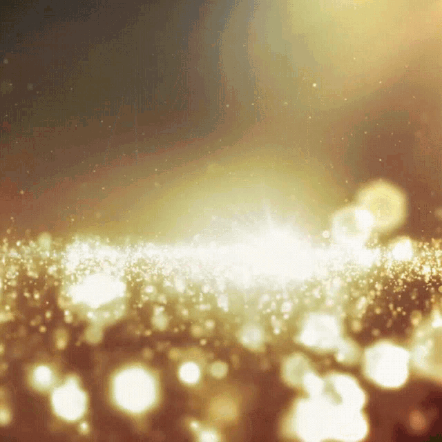 a gold background with a lot of sparkles
