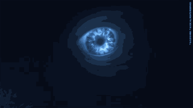 a blue eye is glowing in the dark with a copyright of 2009 on the bottom