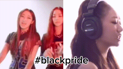 two women are standing next to each other and one is wearing headphones and the other is wearing a black shirt .