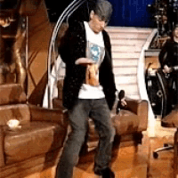 a man in a hat is dancing in a room