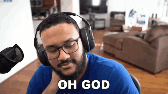 a man wearing headphones and a blue shirt says oh god