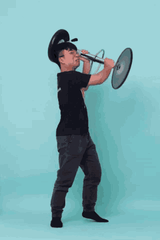 a man in a black shirt with the word thrasher on it is holding a bar stool
