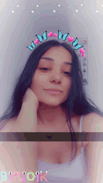 a girl wearing a headband with butterflies and hearts and the word birick on the bottom