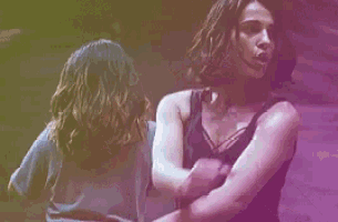 two women are standing next to each other and hugging each other .