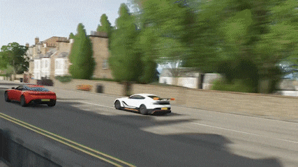 a red car and a white car are racing down a road