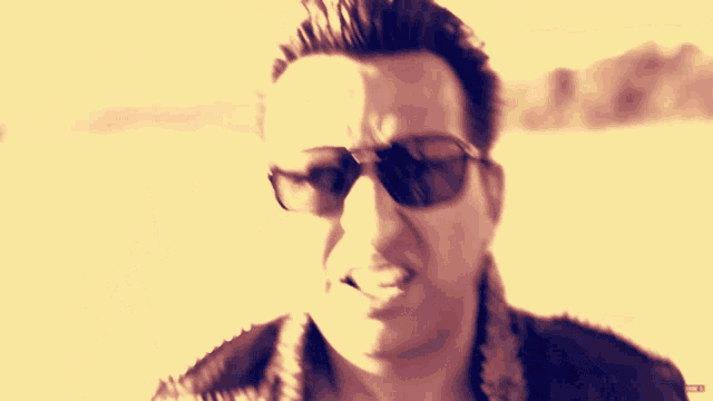 a man wearing sunglasses and a shirt that says kappa on the collar