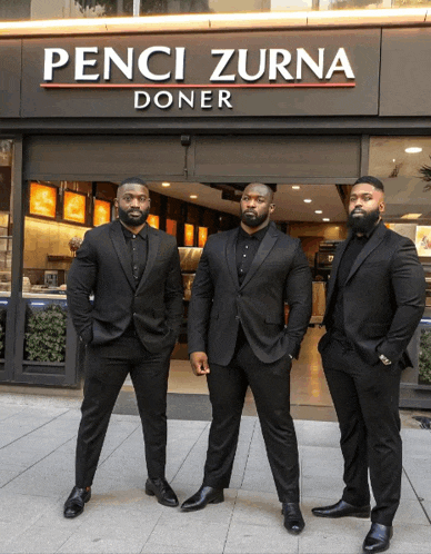 three men standing in front of a penci zurna doner