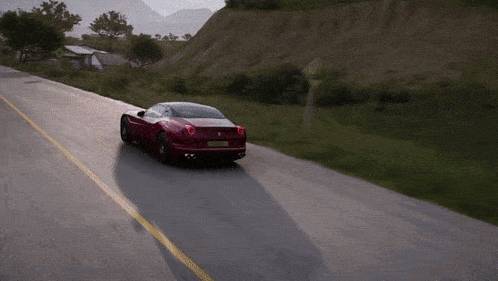 a red sports car is driving down a road with a sign that says no parking