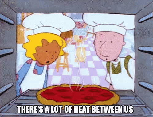 a cartoon of a pizza being cooked in an oven with the words there 's a lot of heat between us .