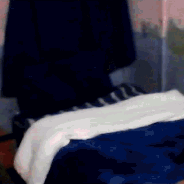 a person is laying on a bed with a white blanket