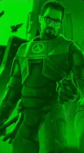 a man with glasses and a beard is standing in a green light .