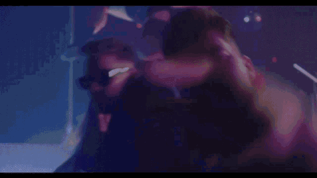 a man wearing sunglasses and a black turtleneck is making a devil horns gesture