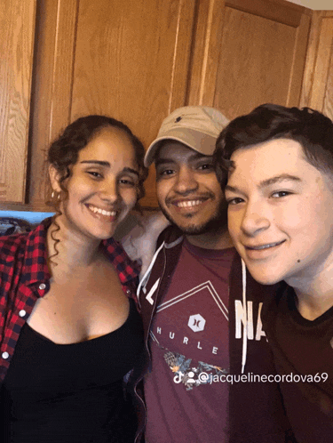 a man wearing a hurley shirt is posing for a picture with two other people