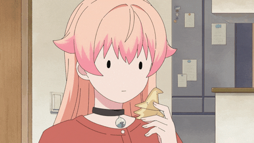 a girl with pink hair is holding a piece of food in front of a fridge