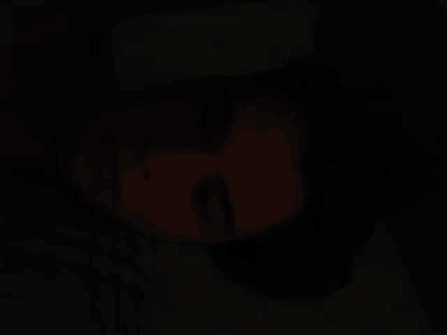 a blurred image of a person 's face in the dark