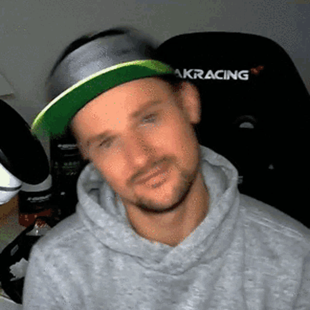 a man wearing a hat that says akracing