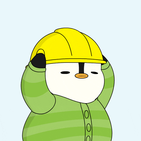 a penguin wearing a yellow hard hat and a green sweater