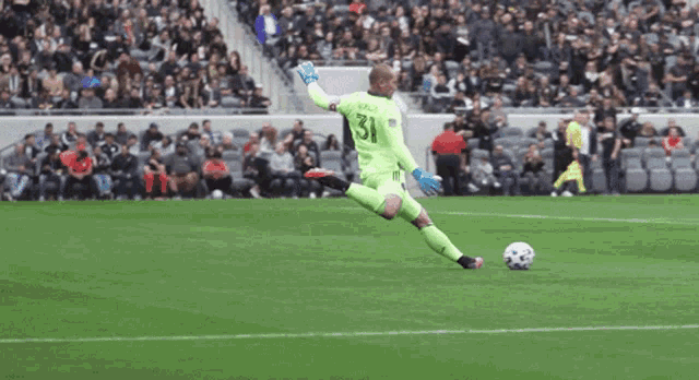 a soccer player with the number 31 on his jersey is kicking the ball