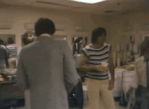 a group of people are dancing in a room with a blurred background