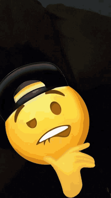 a yellow smiley face wearing a black hat is laying down
