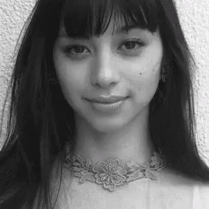 a black and white photo of a woman wearing a choker .
