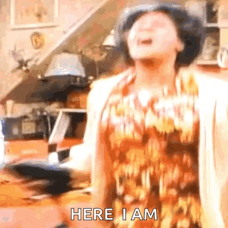 a woman is standing in a living room with her mouth open .
