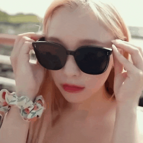 a close up of a woman wearing sunglasses .