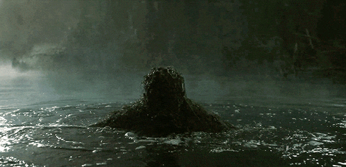 a person is swimming in a dark pool with a dark background
