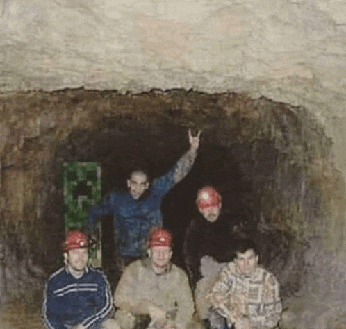 a group of men wearing hard hats are posing for a picture