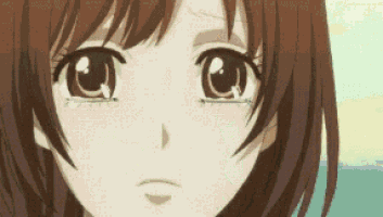 a close up of a girl 's face with a tear coming out of her eye