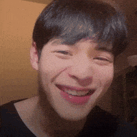 a close up of a man 's face with a smile on it .