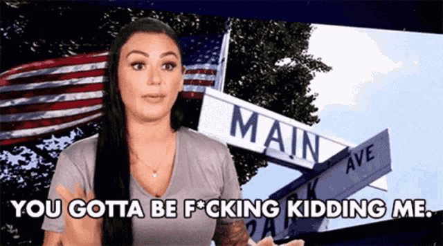 a woman is standing in front of a main ave sign