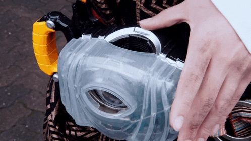 a close up of a person 's hand holding a clear object