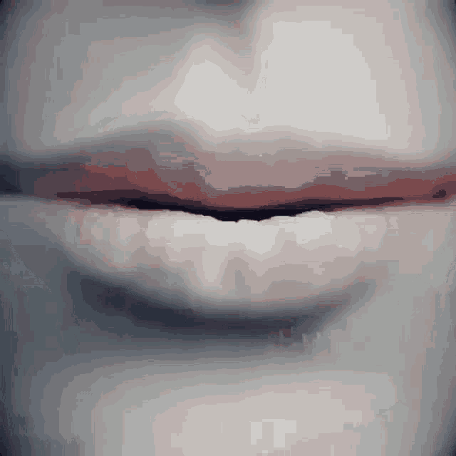 a close up of a woman 's mouth with a few teeth visible