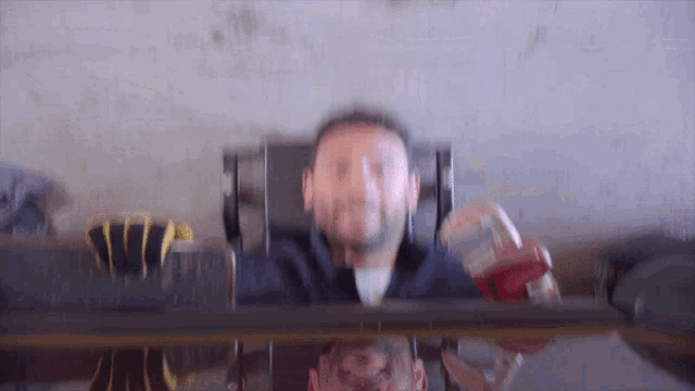 a blurry picture of a man sitting at a table